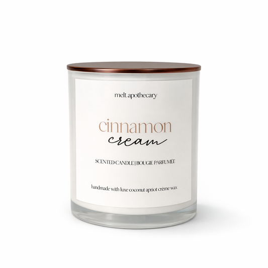 Candle labeled 'cinnamon cream' by Melt Apothecary on a white background