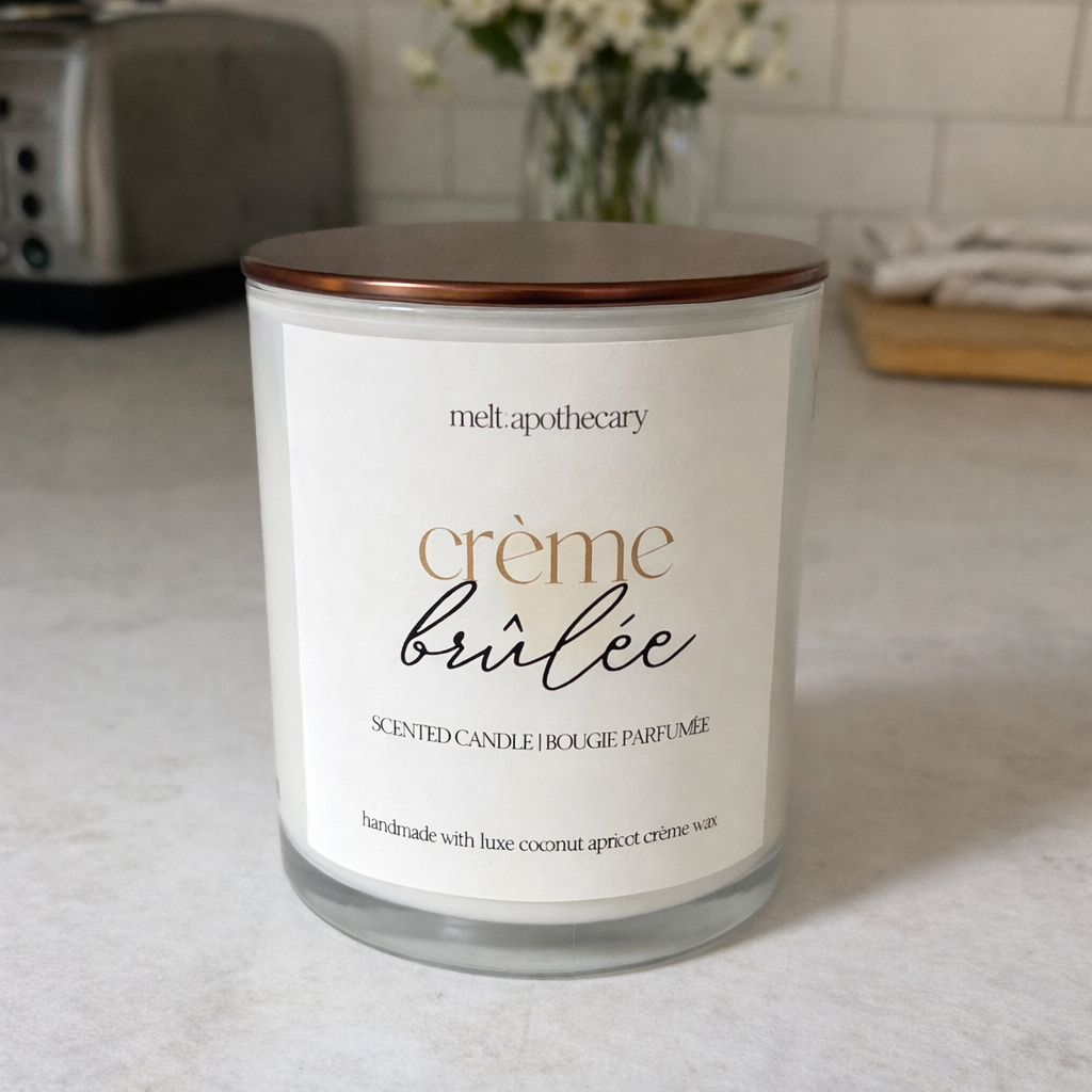 Candle labeled 'creème brélé' by Melt Apothecary on a surface.