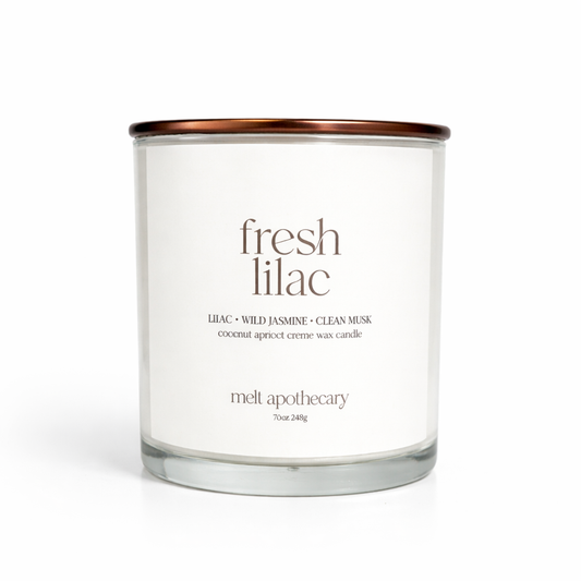 Candle with 'fresh lilac' label on a white background
