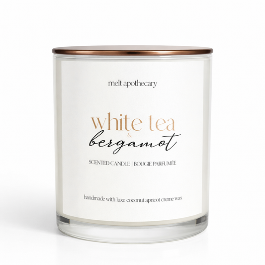 Wooden wick candle with 'melt apothecary' branding and 'White Tea & Bergamot' label on a white background
