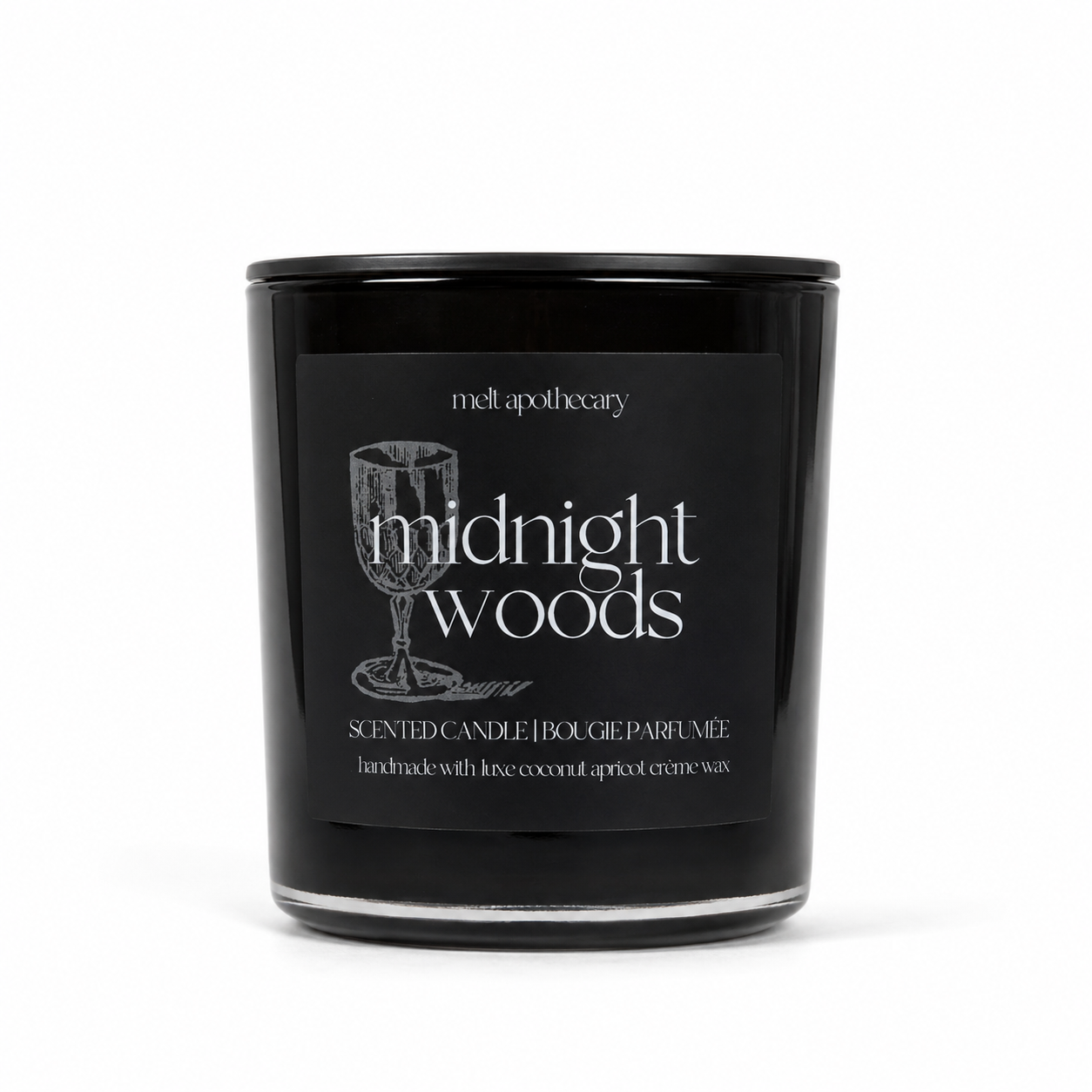 A black glass scented candle jar with a black lid and a black front label reading 'midnight woods' and 'meltpotapothecary'. The label also includes a wine glass illustration and smaller text about coconut and apricot wax.